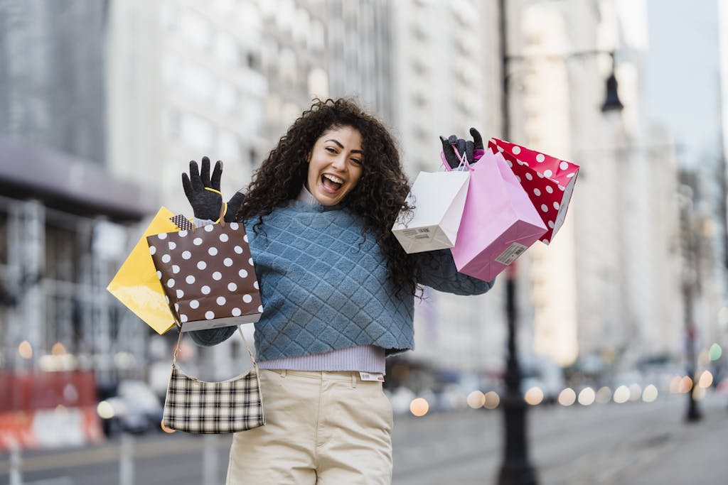 Happy woman with shopping bags, smiling in an urban setting. Vibrant city life captured in a candid moment.
